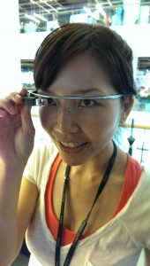 Woman wearing eyeglasses with added transparent rectangular cube in front of the right lens area.