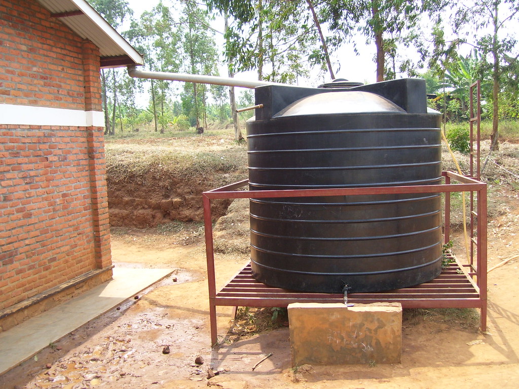 Large (roughly 1,000 gallon) black tank connected to house by the gutter.