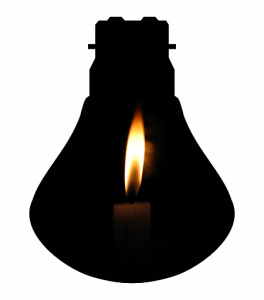 A candle lit inside of an upside down incandescent lightbulb.