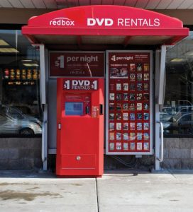 Front view of a RedBox machine. It is advertising DVD rentals for $1.