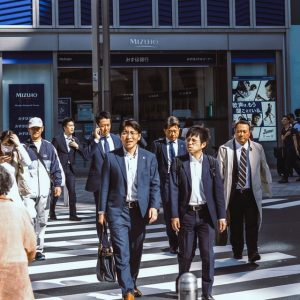 Business people crossing the street at a busy urban intersection