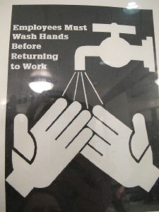 Black and white poster with a handwashing icon stating 'Employees must wash hands before returning to work.'