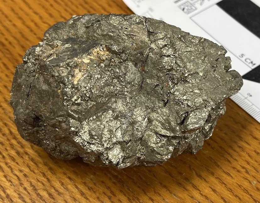 Massive-looking chunk of metallic gold-colored mineral.