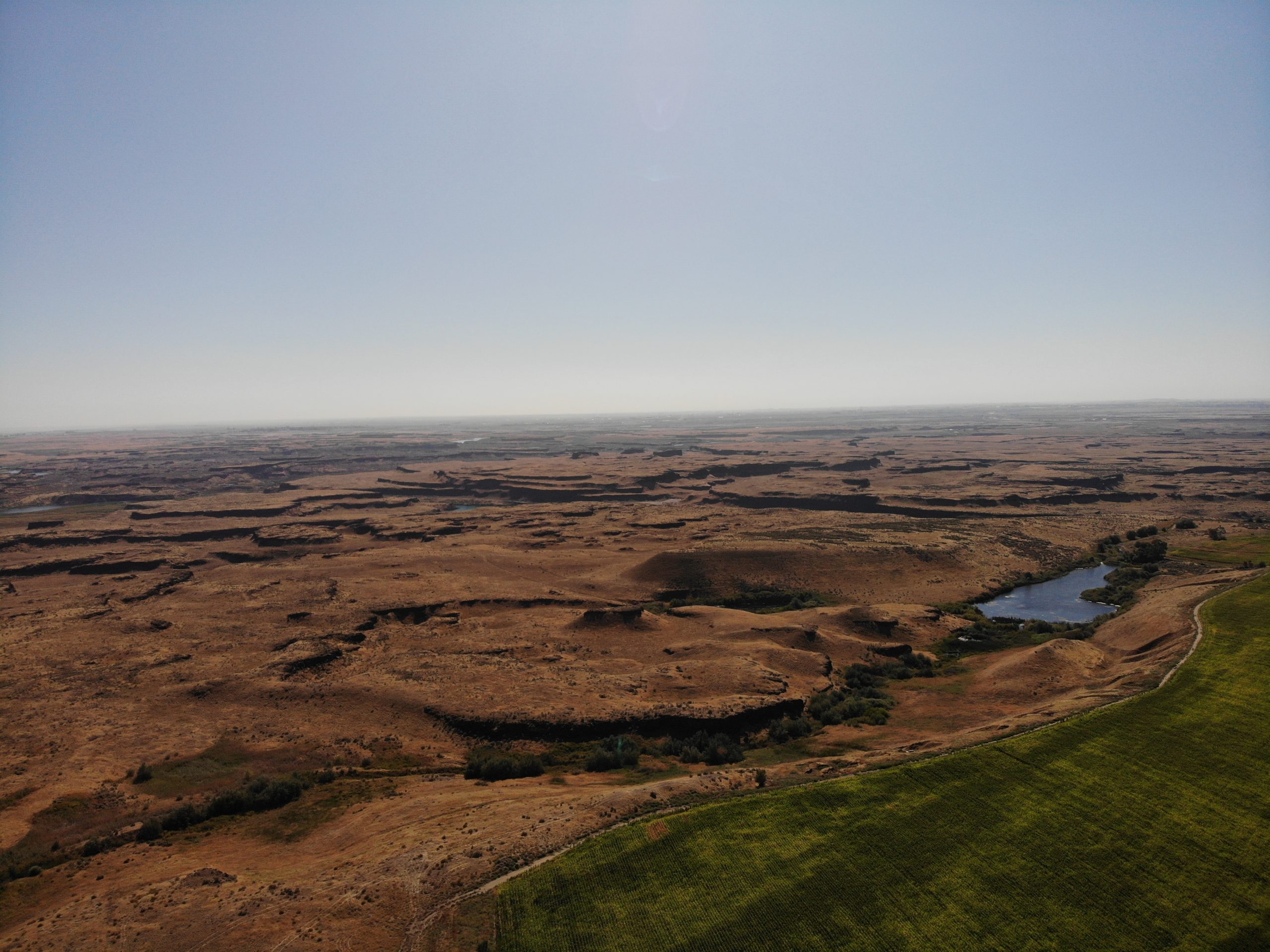 Aerial photo of a barren and pockmarked terrain.