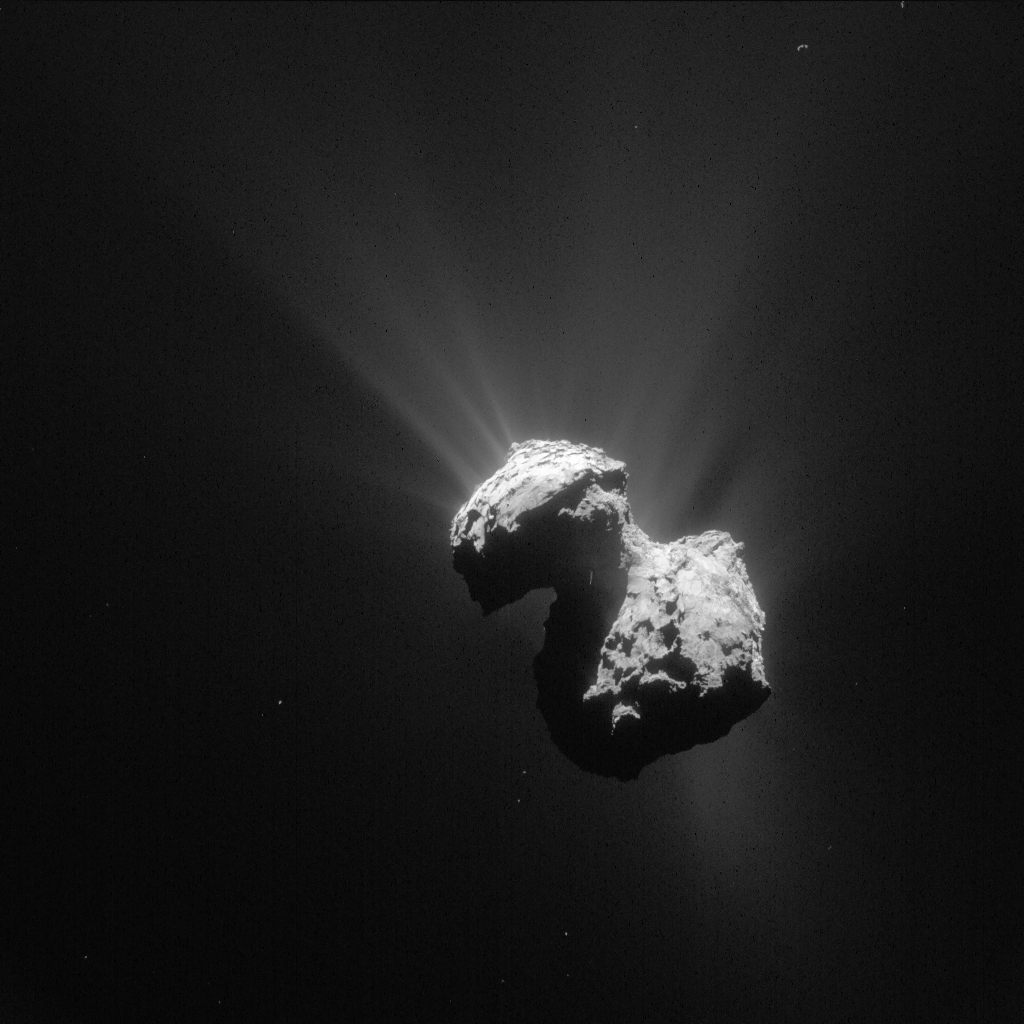 Gray dumbbell-shaped comet that has gaseous jets coming off of the comet's surface.