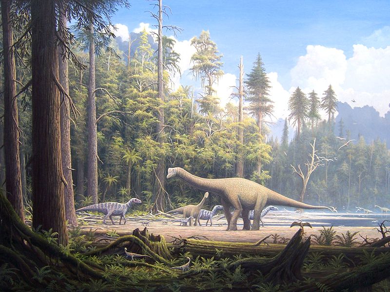 Illustration of several dinosaurs walking on sandy beach with lush green forest in the foreground and background.