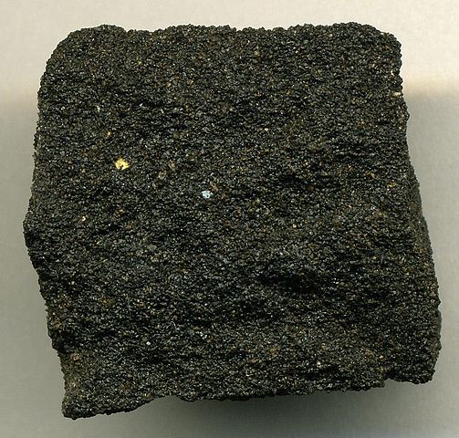 Blocky chunk of sandstone that is black in color due to being filled with tar.