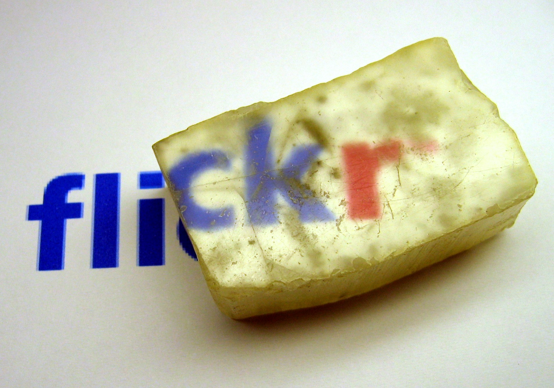 The word on the page can be seen through the mineral, and is slightly magnified.