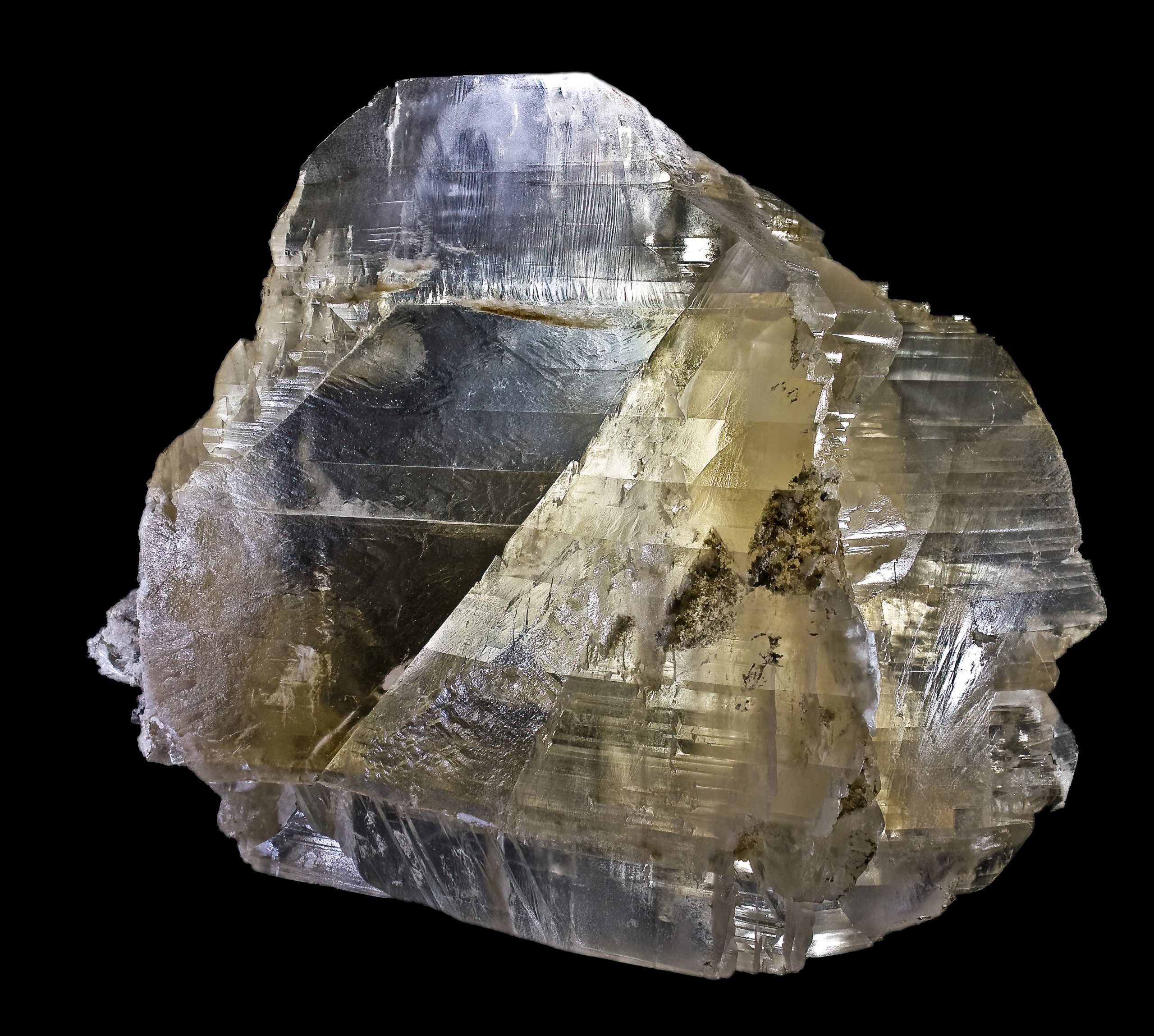 Glassy, clear mineral that has many horizontal lines on it.