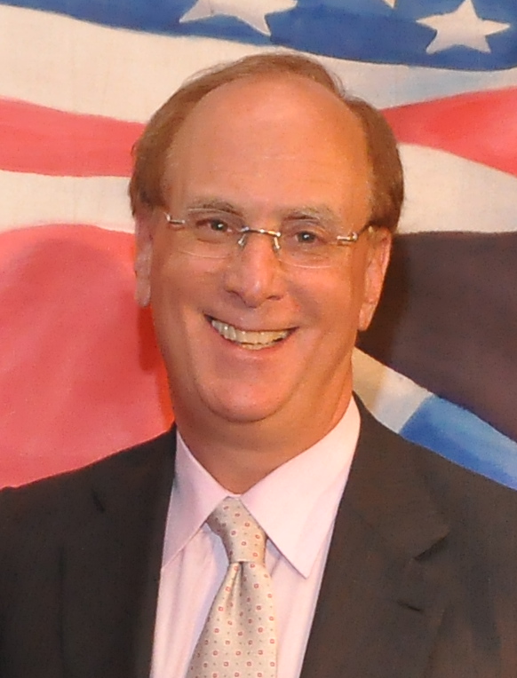 Portrait of a middle-aged white man wearing a suit and glasses