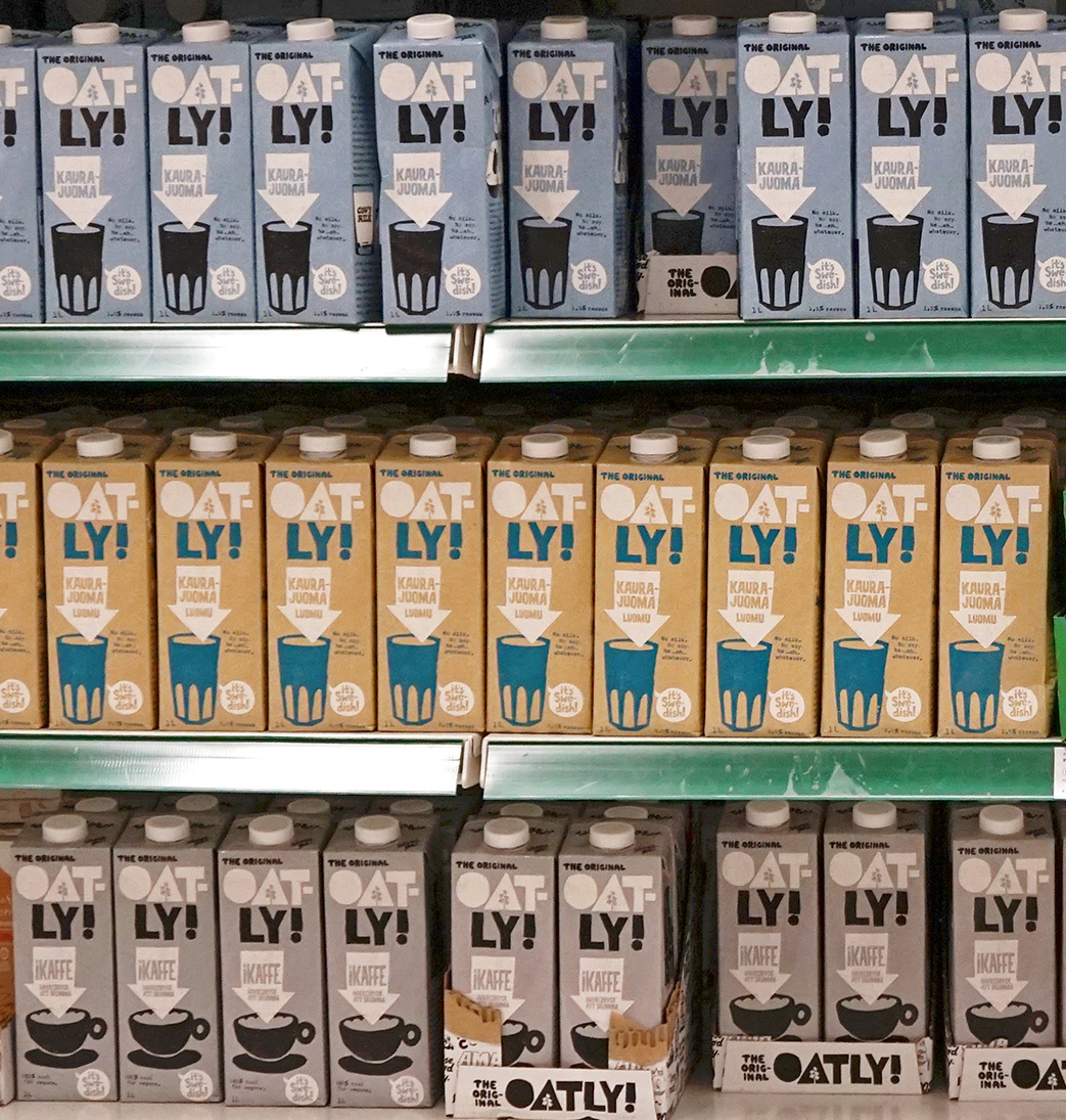 Three different variations of Oatly milk on the store shelves