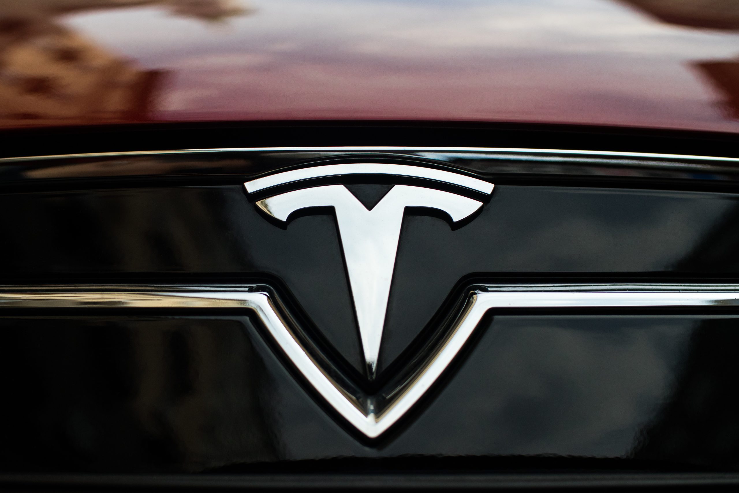 Close-up image of Tesla emblem on the car