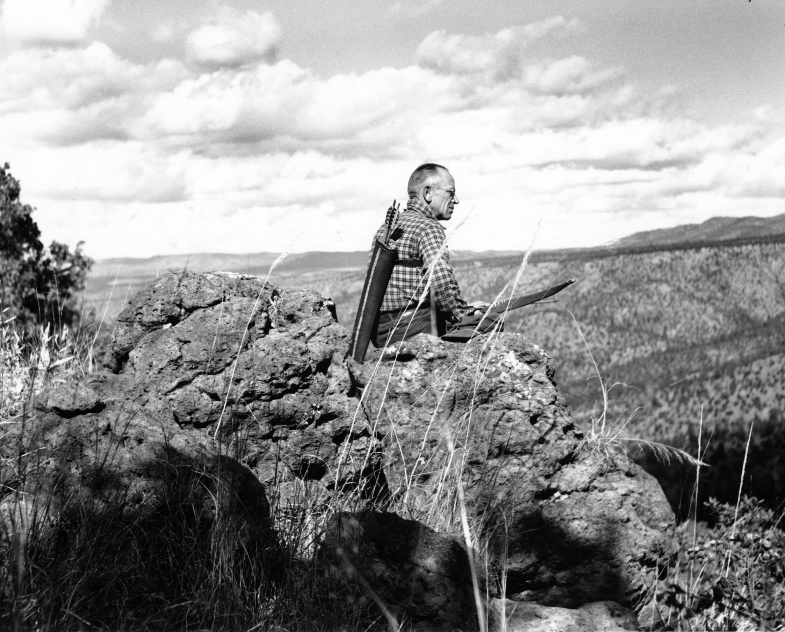 Aldo Leopold on rocky terrain looking over Sierra Madre