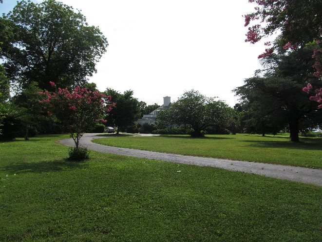 photo of a well manicured lawn with trees on the border