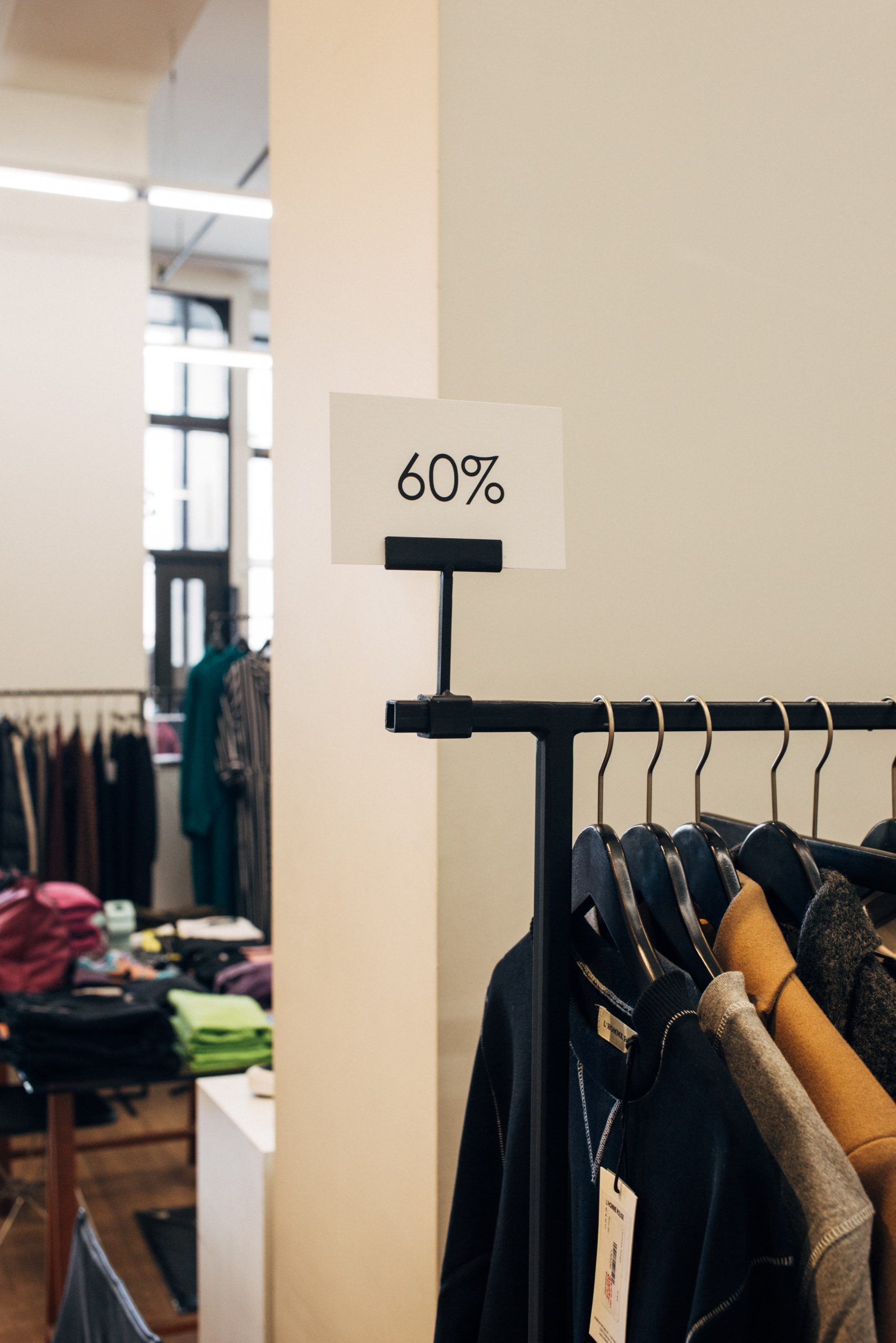 Photo of a rack of clothes labeled 60% off.