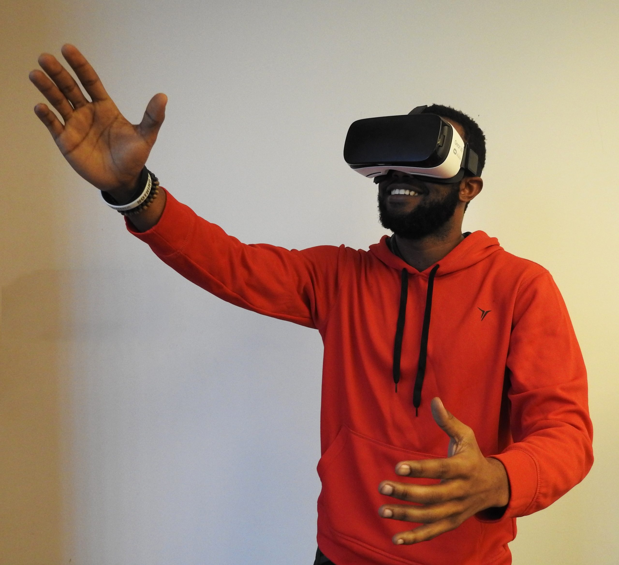 Photo of a person in a red sweatshirt wearing a VR headset