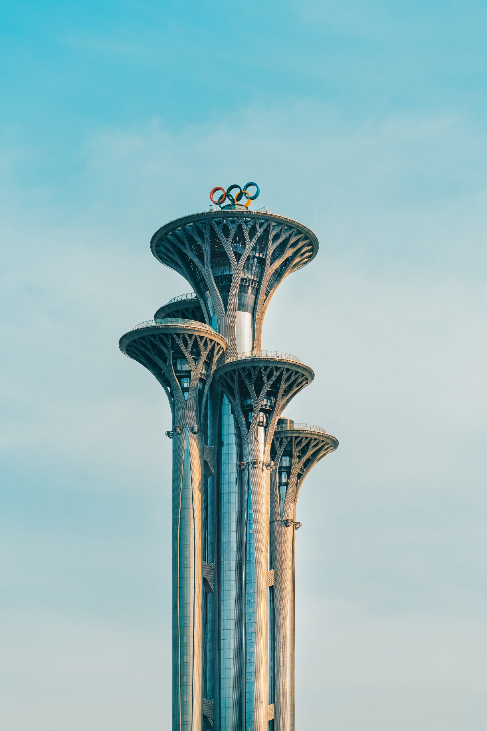 Modern skyscrapers with the olympic rings on top.