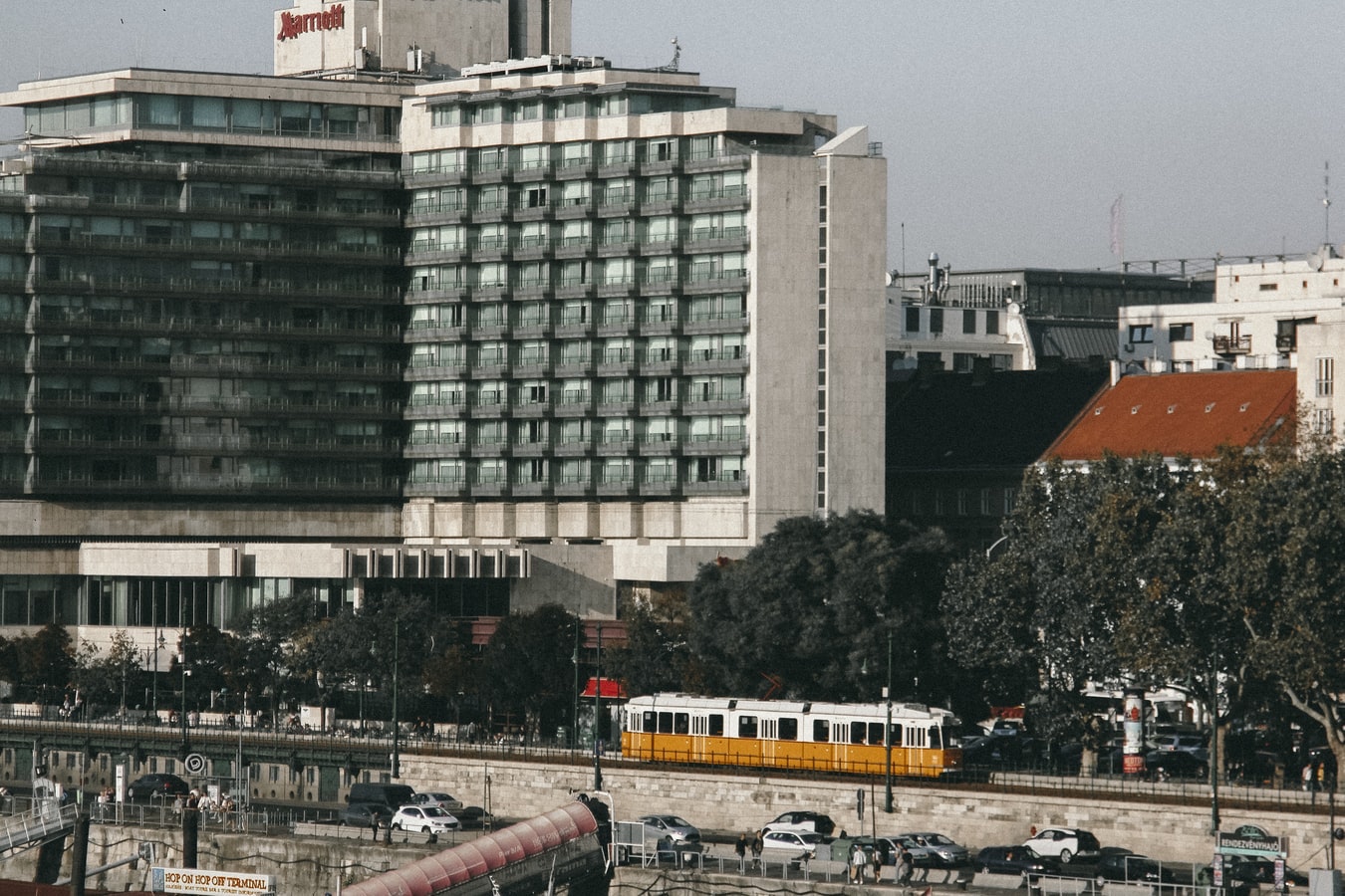 Picture of a Marriott hotel in Budapest. A tram is on tracks in front of the building.