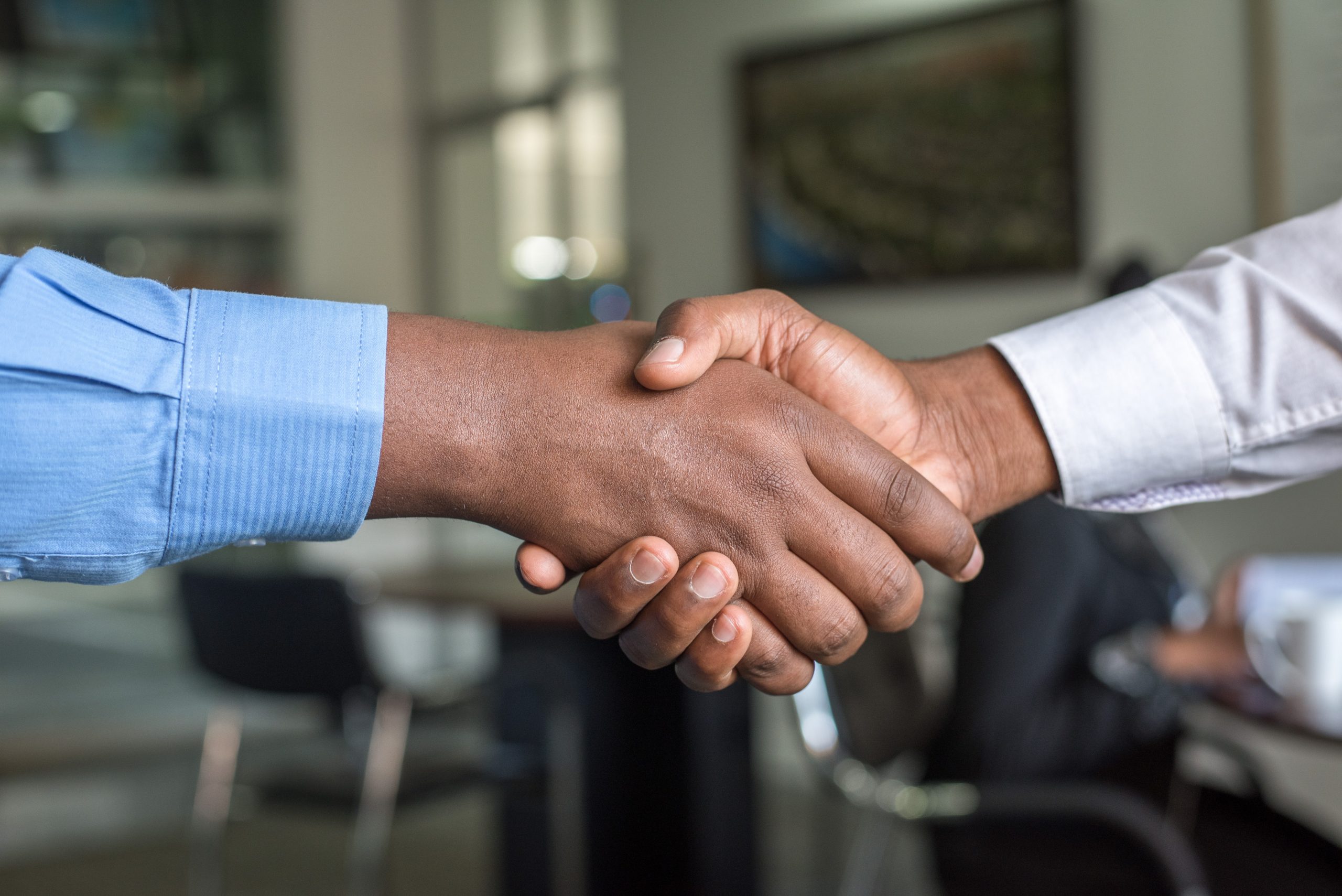 Up close photo of 2 people shaking hands.