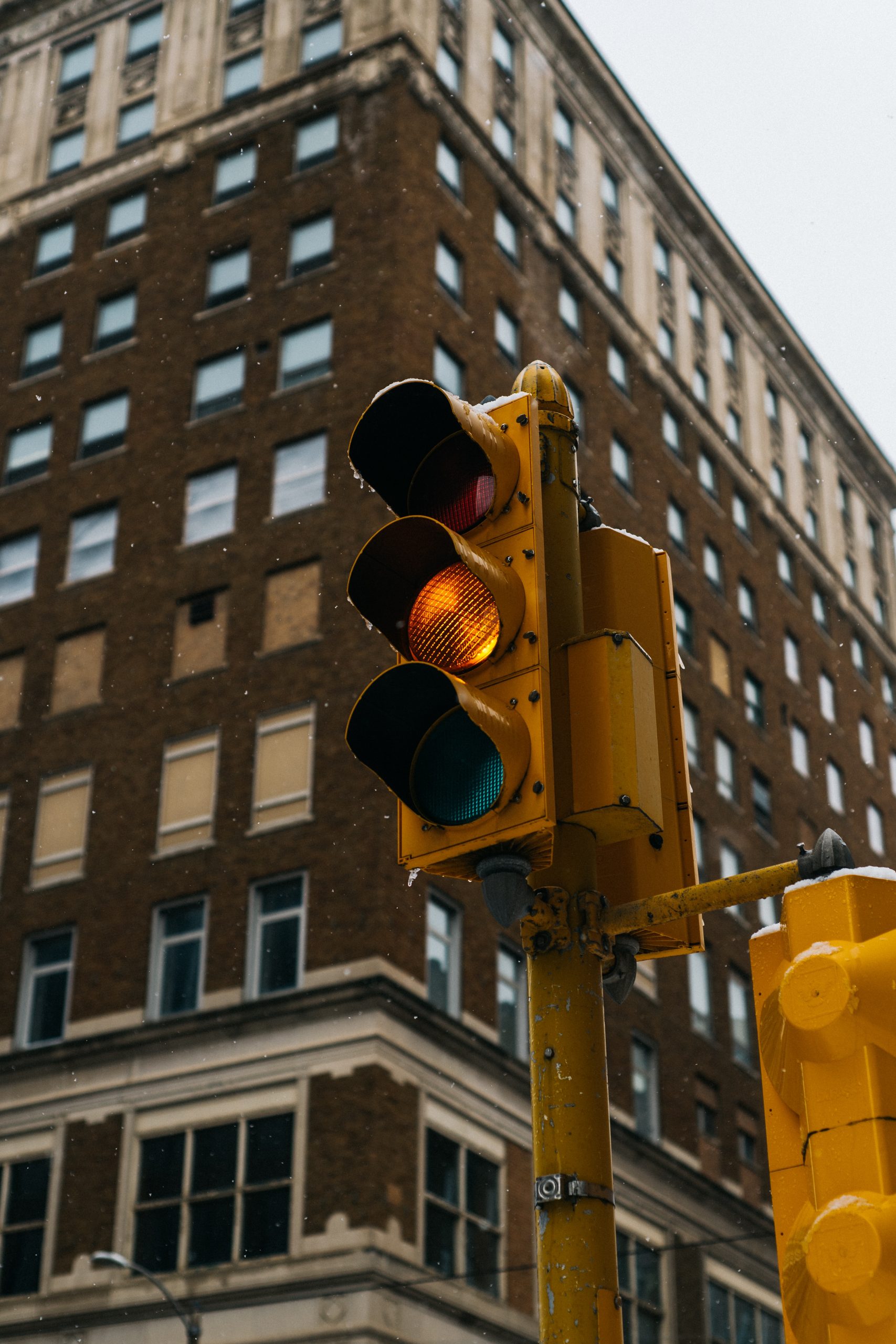 Close up photo of a stoplight. The light is yellow.