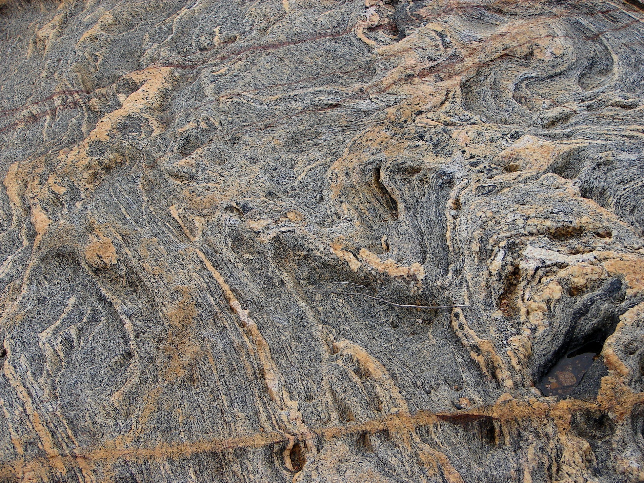 Grey-and-orange rock with wavy texture.