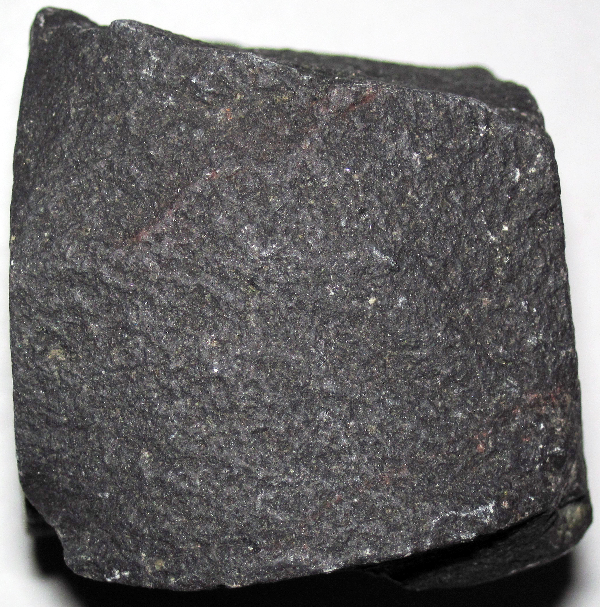 Show dark rock with no visible minerals
