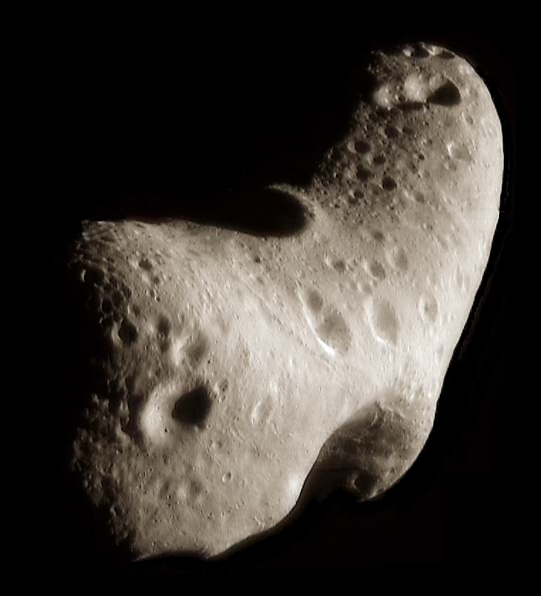 Image of the Asteroid Eros. Like nearly all asteroids, Eros is not spherical but very irregular in shape, in this case similar to a potato. The surface is pock-marked with many craters.