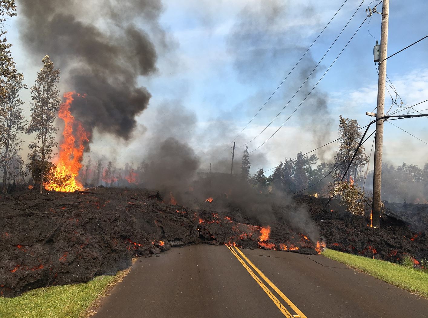 Lava from Kiluea destroying road in Hawaii.