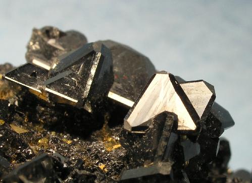 Dark brown, shiny, opaque crystals with 3 sides morphed together to form one mineral